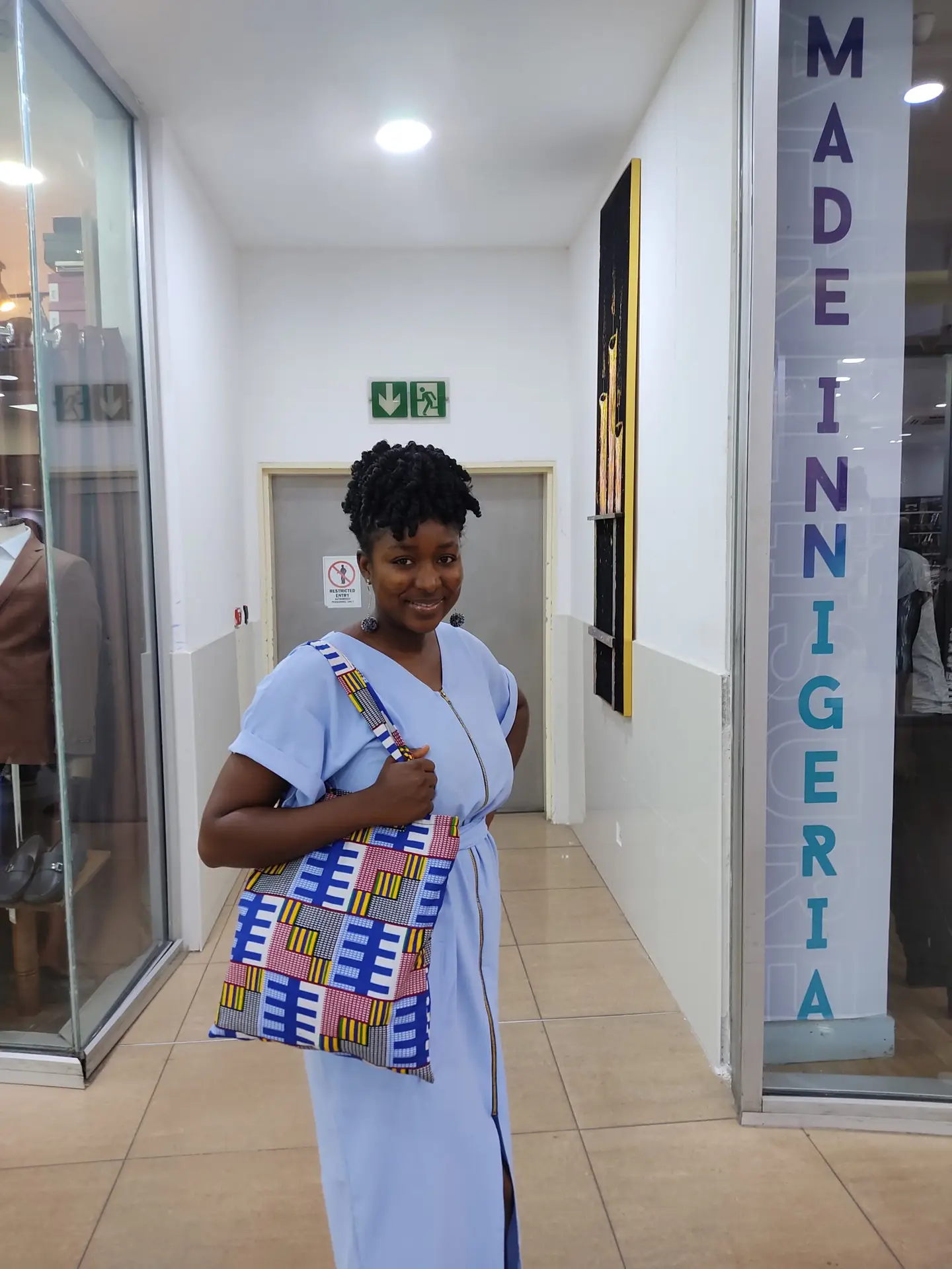 Teyei holding an ankara tote